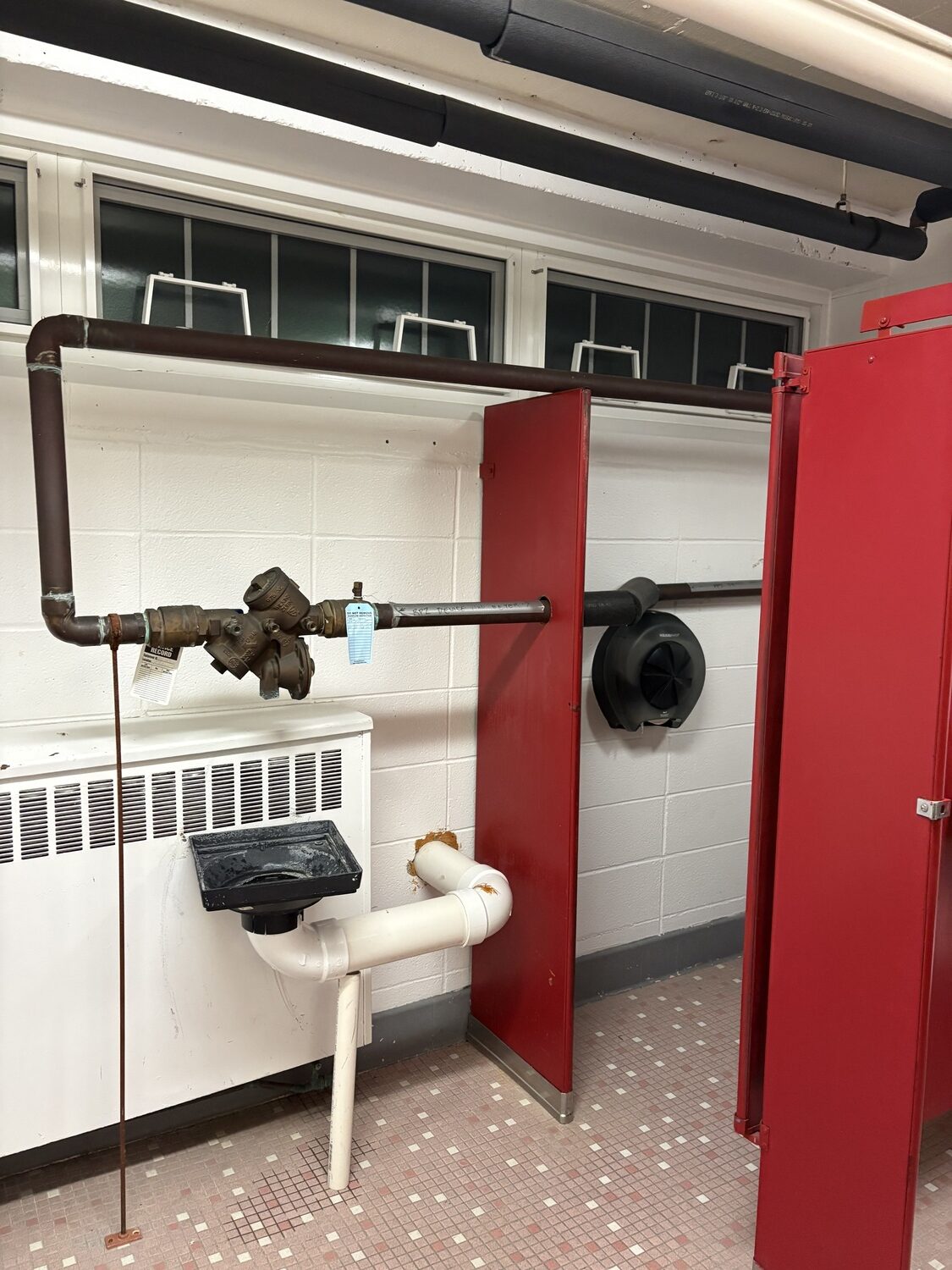 Exposed pipes exist throughout the locker rooms. CAILIN RILEY