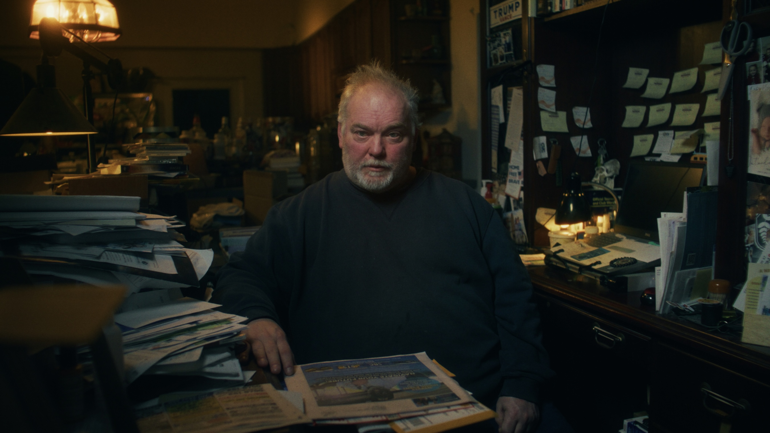 Mike Carroll sitting at his desk at his home, taken from his interview.