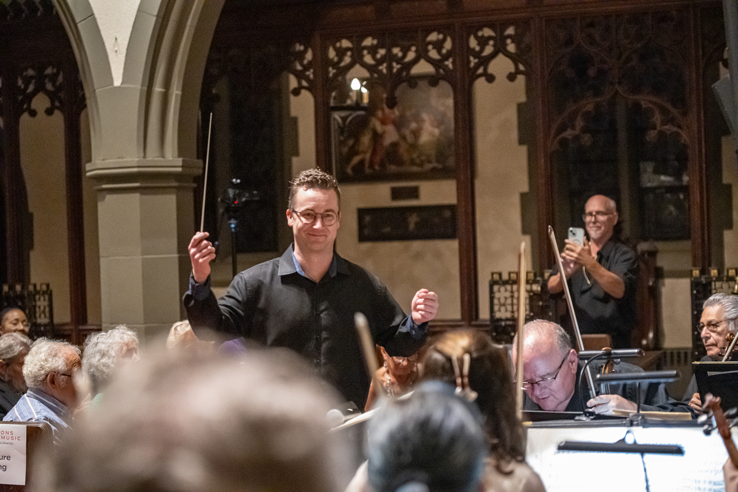 TH·FM associate conductor Logan Souther conducts a mainstage performance in September at St. Luke's Church. DANE DUPUIS