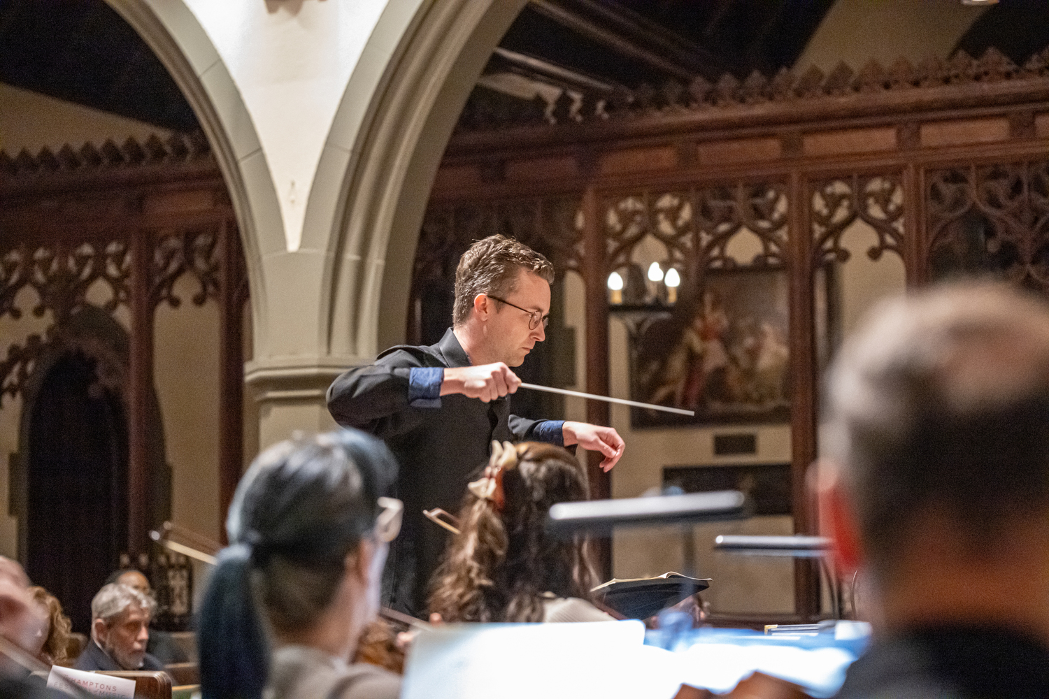TH·FM associate conductor Logan Souther conducts a mainstage performance in September at St. Luke's Church. DANE DUPUIS
