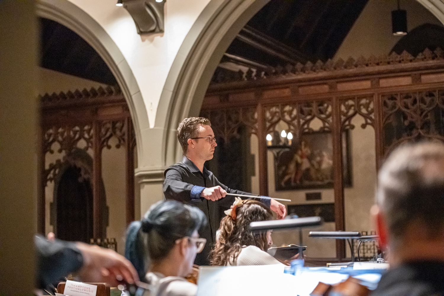 TH·FM associate conductor Logan Souther conducts a mainstage performance in September at St. Luke's Church. DANE DUPUIS