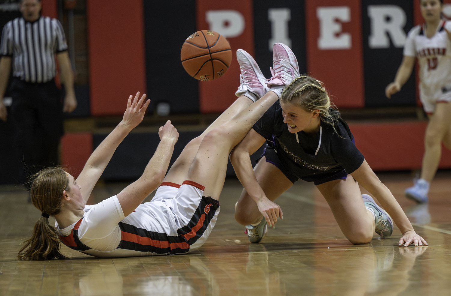 Pierson sophomore Josie Mott and Hampton Bays senior Taylor Meyers go after a loose ball. MARIANNE BARNETT
