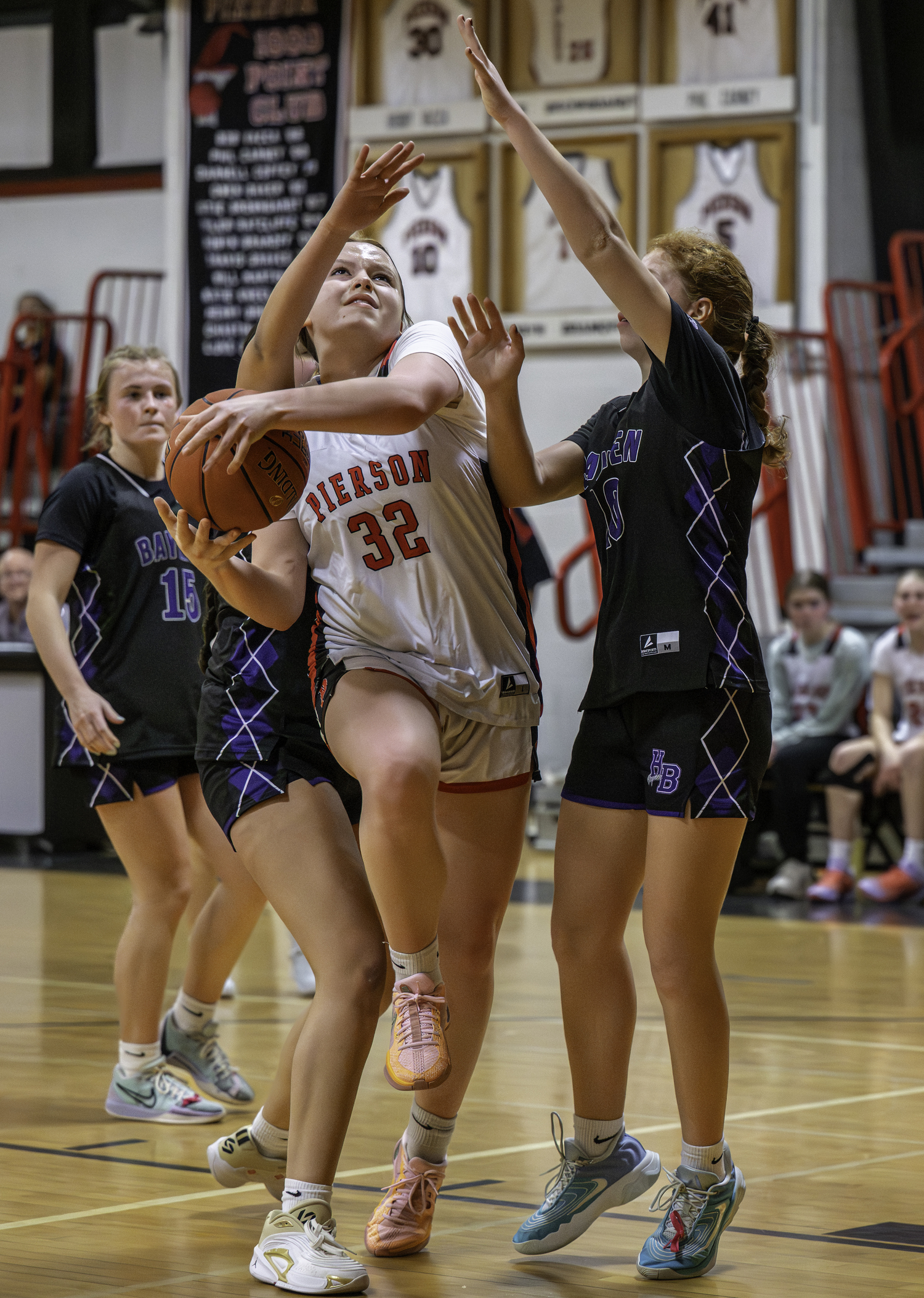Pierson junior Skye Smith battles a pair of Baymen defenders in the paint.  MARIANNE BARNETT
