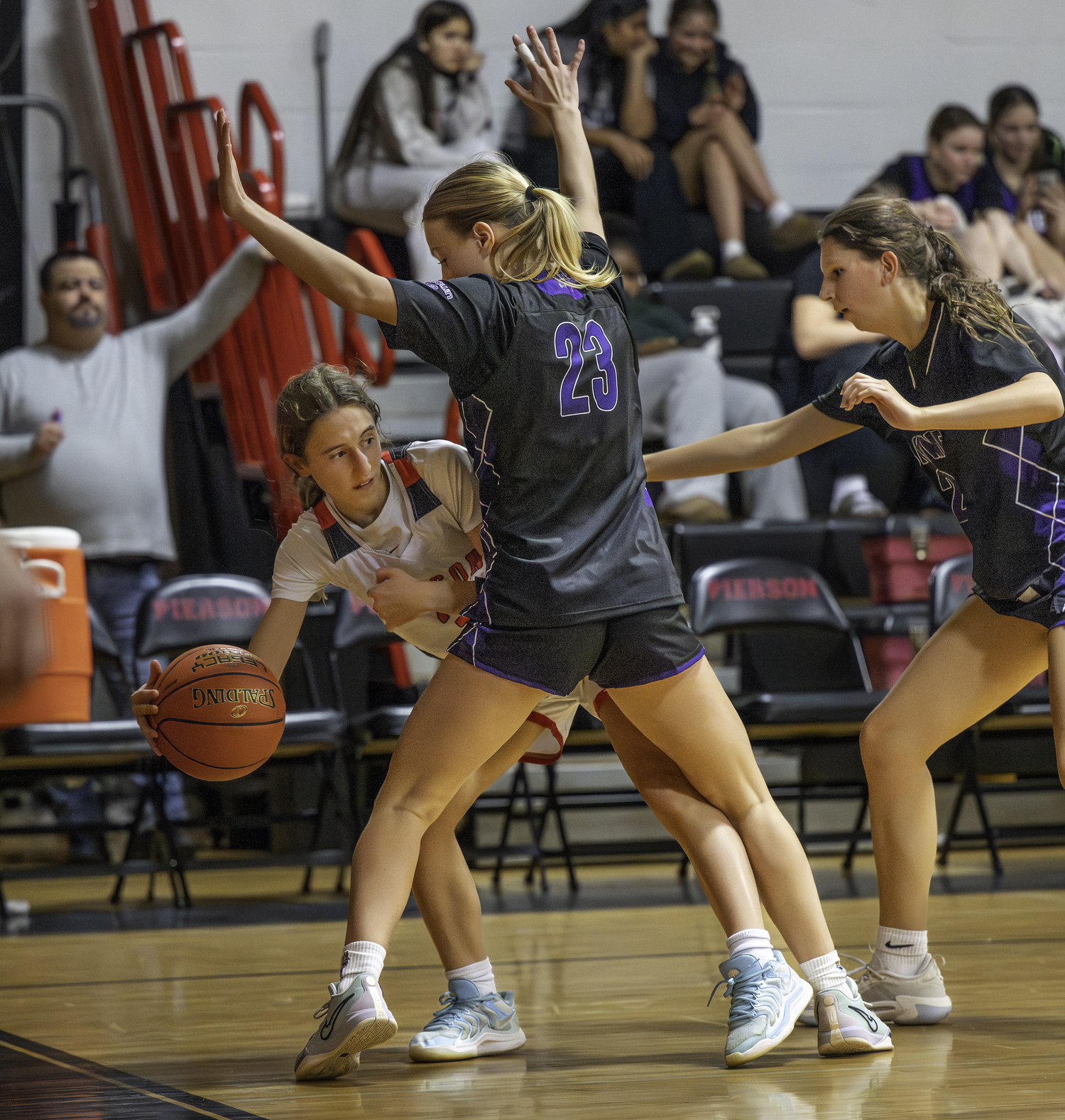 Pierson sophomore Molly Wolfson looks to pass around Hampton Bays senior Eden Brown.  MARIANNE BARNETT