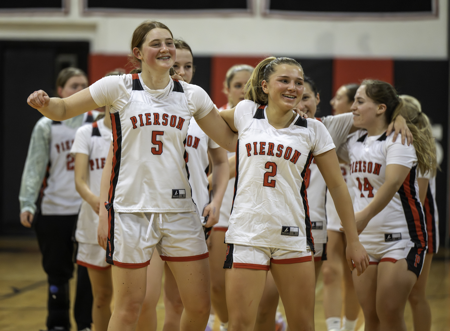 Josie Mott, left, and Abby Perello and the rest of the Whalers are all smiles after starting the season 2-0.  MARIANNE BARNETT