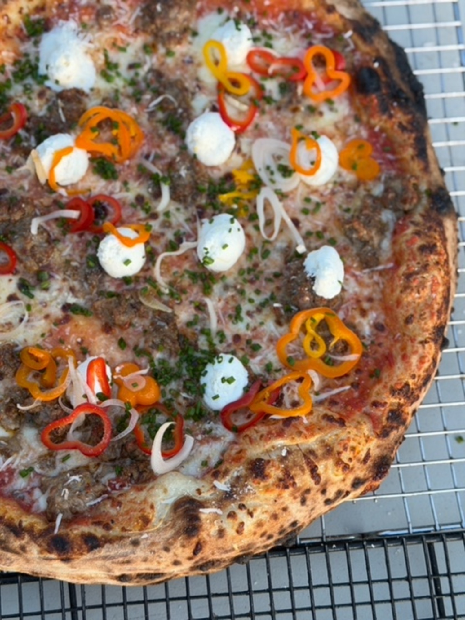 Pizza inspired by Chef Andrew Mahoney’s venison sausage version at the annual Farmer & Hunters Feast at Sagaponack Farm Distillery. ROBYN HENDERSON-DIEDERIKS