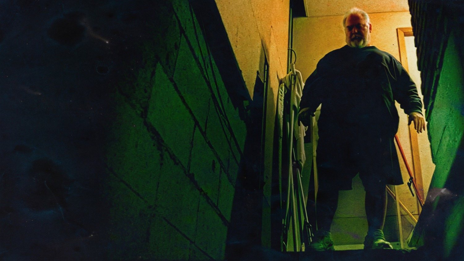 Mike Carroll stands at the top of the basement stairs in Patricia E. Gillespie's documentary 