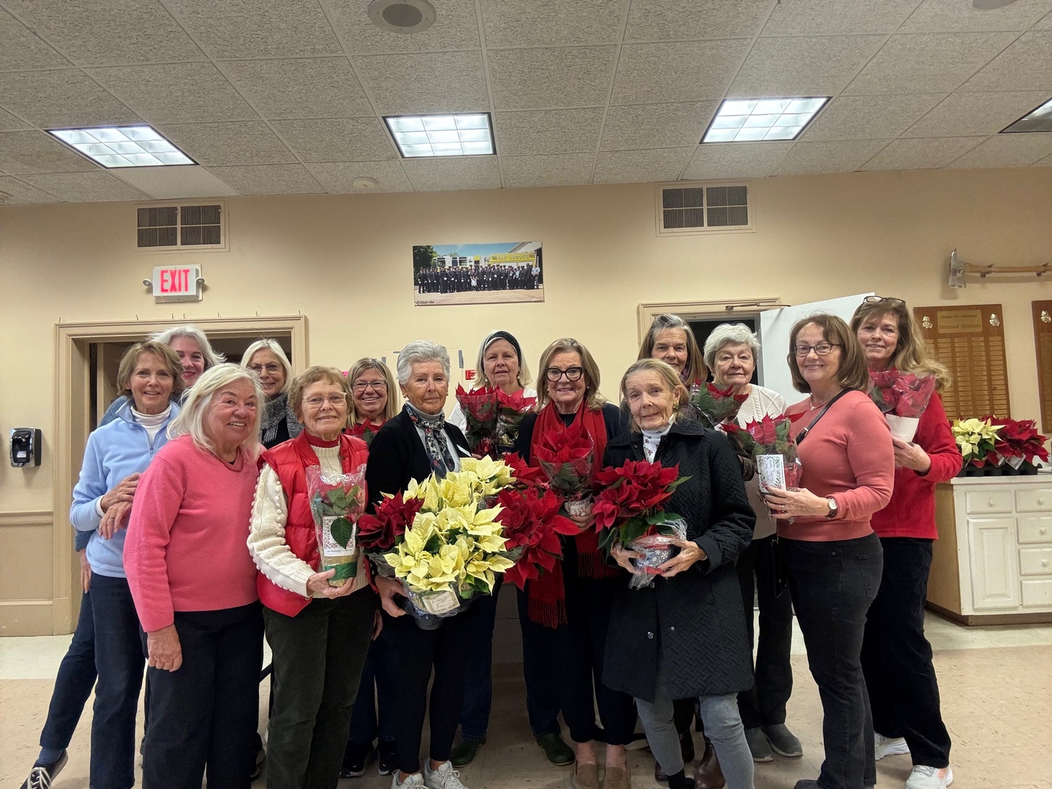 Members of the Westhampton Garden Club gathered at the Quogue Firehouse to wrap and decorate poinsettia plants for East End Hospice patients at the Kanas Center and throughout the East End.  Each plant included a personal message from the garden club member who decorated the plant. COURTESY WESTHAMPTON GARDEN CLUB